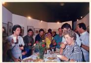 Convívio de atores em exposição de arte e beberete.